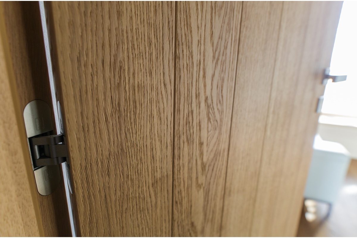 Family house interior - A sliding oak door, reaching all the way up.