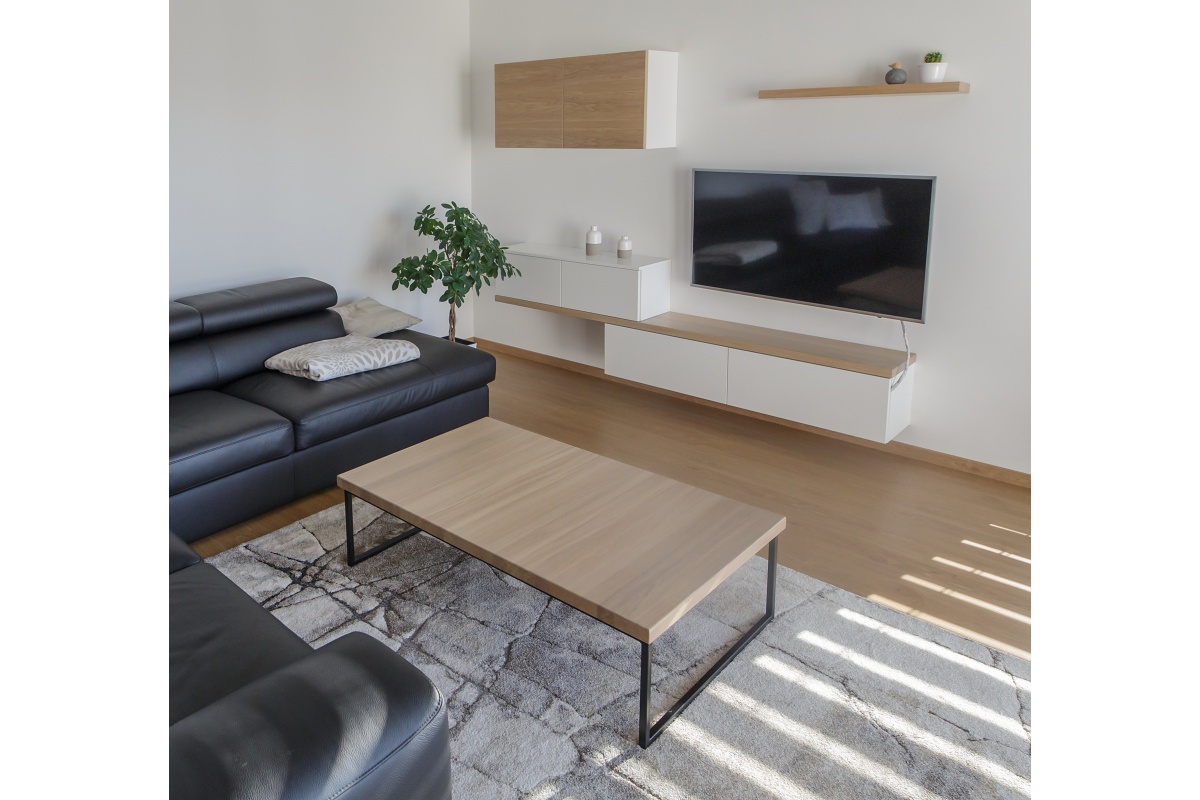 Family house interior - The kitchen with a plenty of storage space is built from oak veneer and equipped with first-rate Blum ironwork. The corner cabinets have a practical sliding storage system installed.