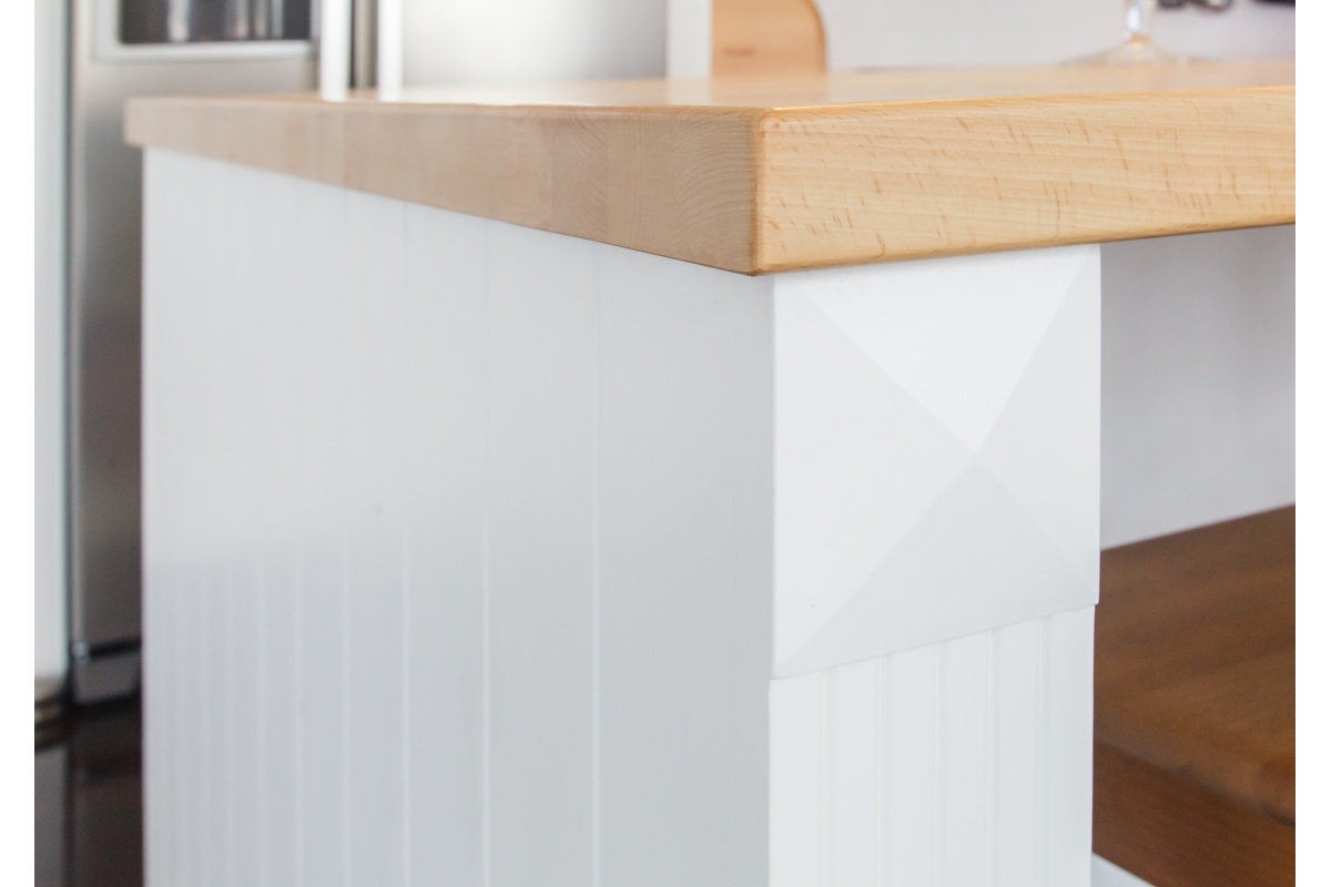 Family house  - Bottle compartments are placed above the fridge. The entire kitchen is decorated with a moulding.