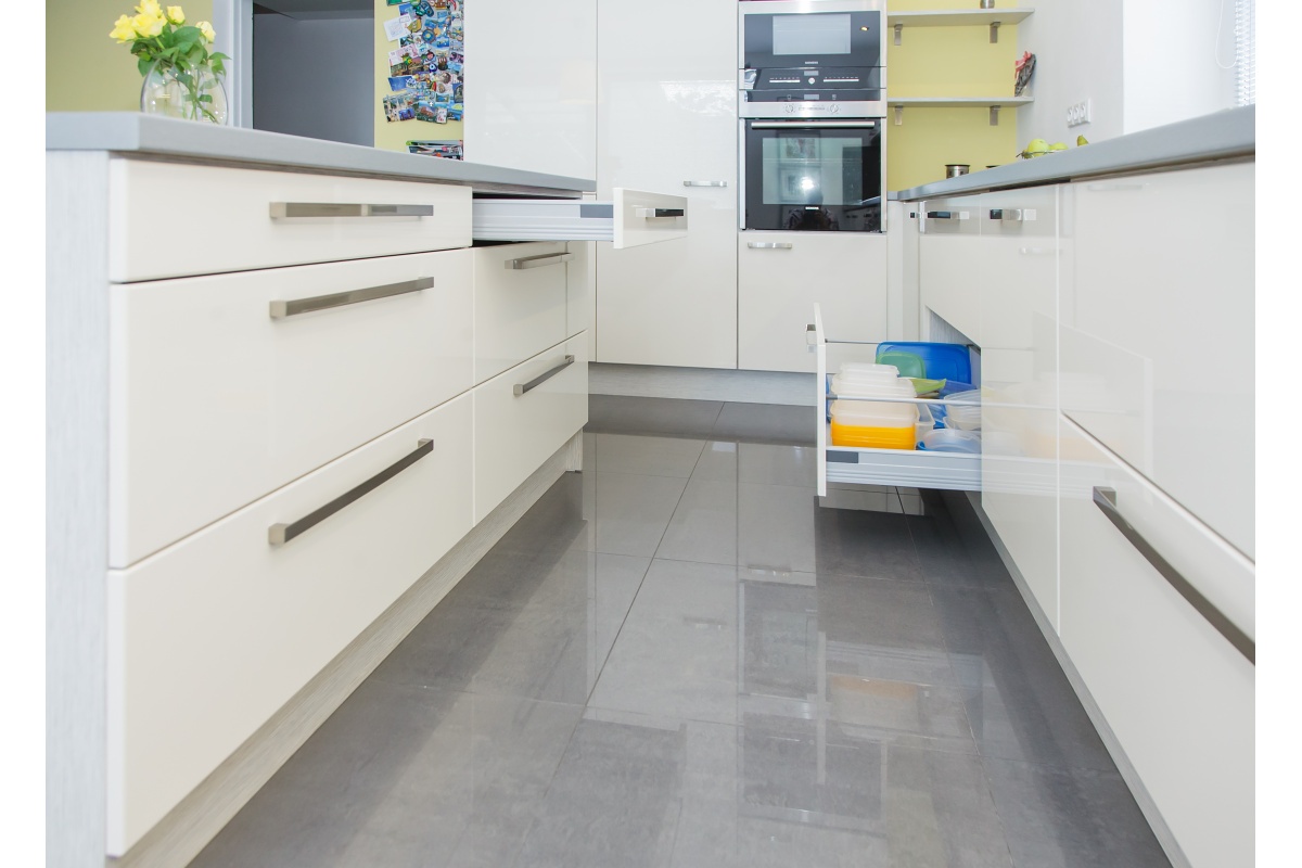 Kitchen - The kitchen island’s storage space can be accessed from the kitchen and the living room.